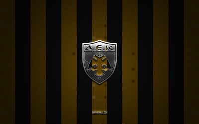 شعار aek athens fc, فريق كرة القدم اليوناني, الدوري الممتاز اليونان, أسود الكربون الأصفر الخلفية, شعار نادي أيك أثينا لكرة القدم, كرة القدم, أيك أثينا إف سي, اليونان, شعار aek athens fc المعدني
